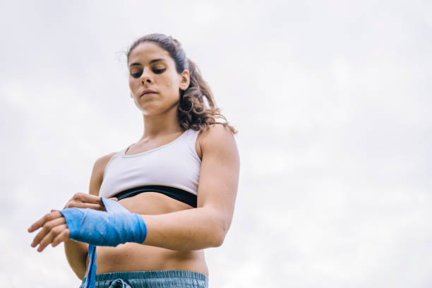 istock Young woman practicing kickboxing outdoors 1062578688