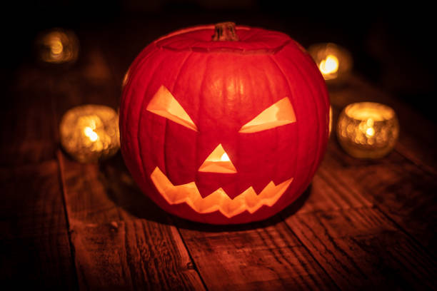 istock Halloween pumpkin with candles and orange glow 1062578716