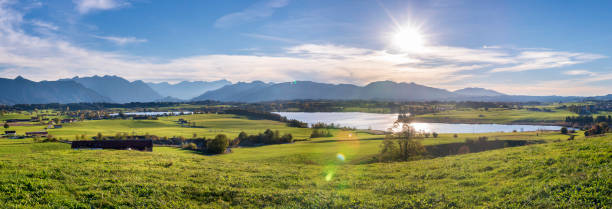 istock panoramic scene at Bavarian alps mountain range and lake Riegsee 1062587412