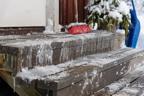 icy stairs infront of a red wooden house in varmland, sweden