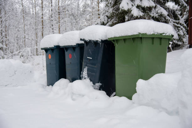 four trash cans standing in lots of snow