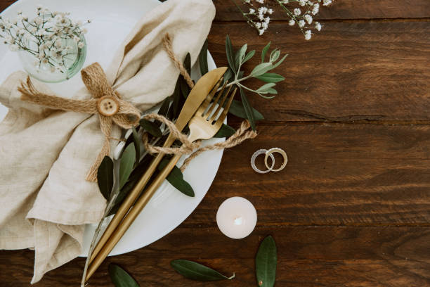 istock Rustic wedding table decorations on wooden table. Top view. Bohemian wedding tableware 1062589770