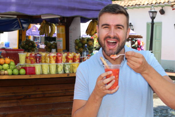 istock Man eating assorted fresh sliced fruits 1062589944