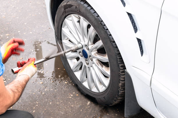 istock technician unscrews car wheel by lug wrench 1062591660