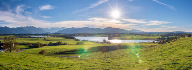istock panoramic scene at Bavarian alps mountain range and lake Riegsee 1062601074