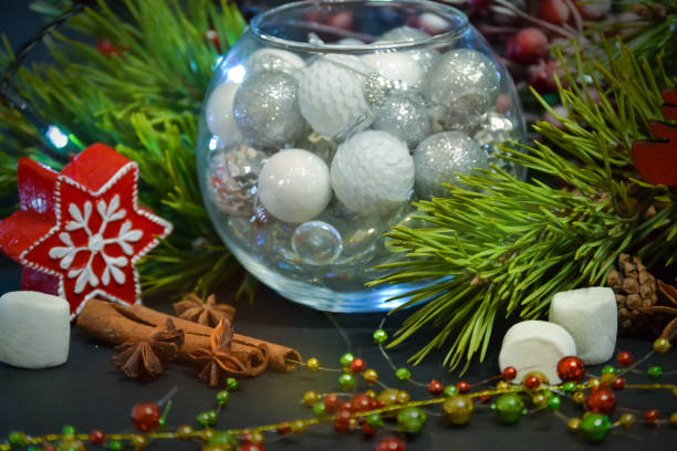 istock Beautiful Christmas decorations in a round glass. Spruce branches, light. candles, marshmallows. New Year's composition. 1062601224