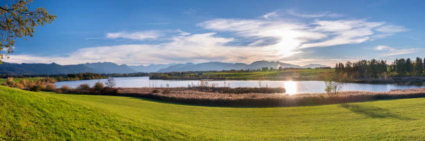 istock panoramic scene at Bavarian alps mountain range and lake Riegsee 1062601468