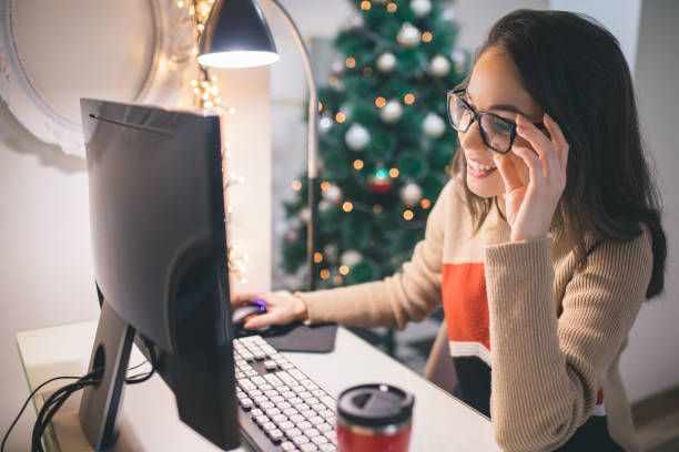 Businesswoman freelancer working at a computer at Christmas stock photo
