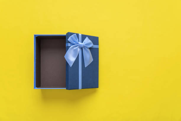 istock Gift box on a yellow background. Close-up. 1062604452