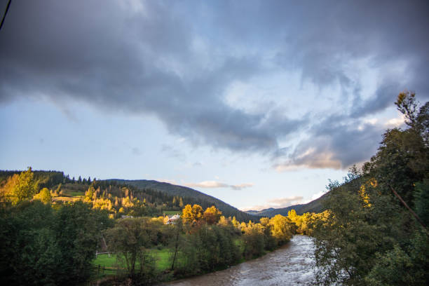 istock Stormy mountain river with autumn trees in the background. 1062604520
