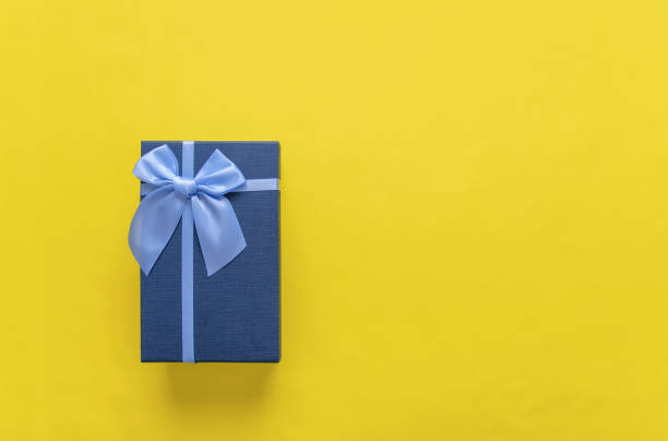istock Gift box on a yellow background. Close-up. 1062605566
