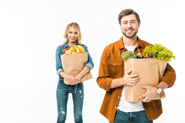 istock man holding shopping bag with products while his girlfriend standing behind isolated on white 1062607870