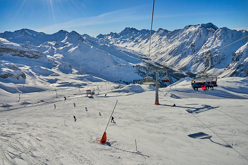 Ischgl, Austria - December 25, 2017: Winter resort and ski slopes between mountains on the background