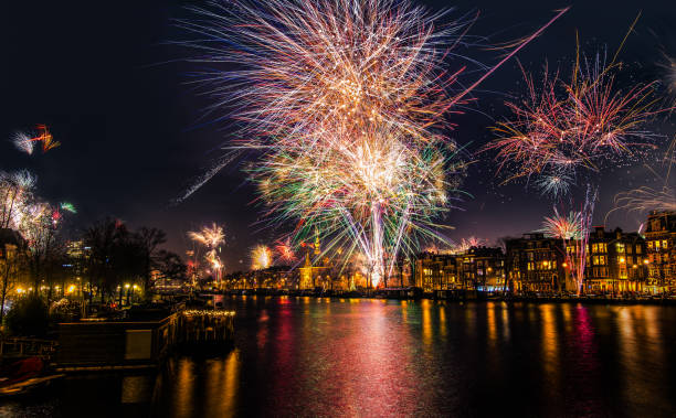New Year's Eve fireworks over the Amstel River in Amsterdam, North Holland, the Netherlands stock photo