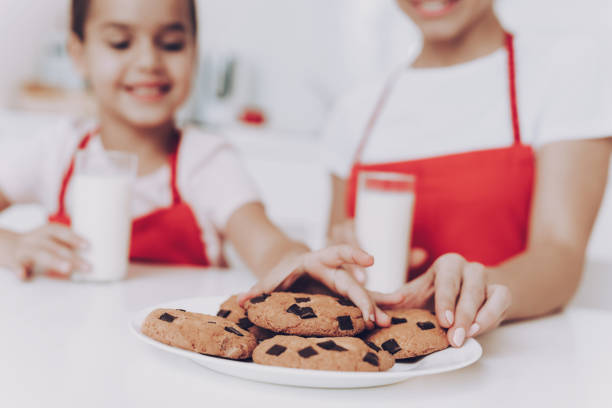 istock People Eating and Drinking Milk in the Kitchen. 1062626950