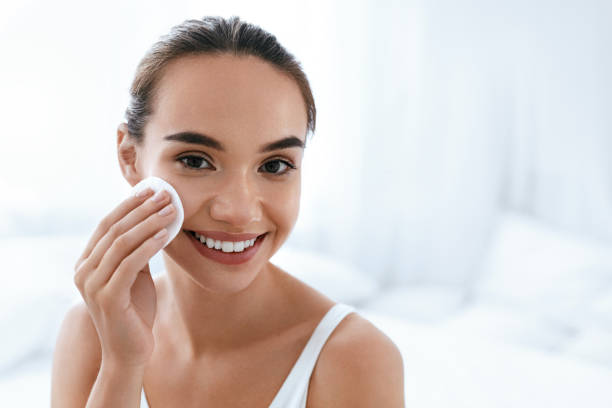 istock Makeup Remove. Girl Cleaning Face Skin With Cosmetic Pad 1062630774