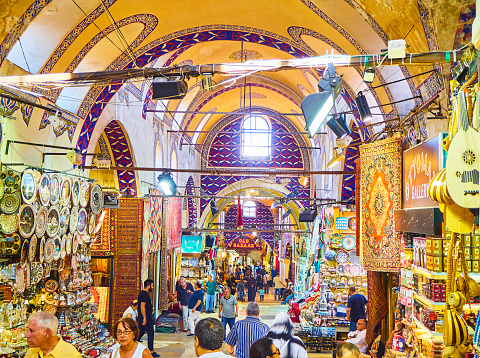 Istanbul, Turkey - July 11, 2018. Tourists at the passageways of the Kapali Carsi, The Grand Bazaar of Istanbul, Turkey.