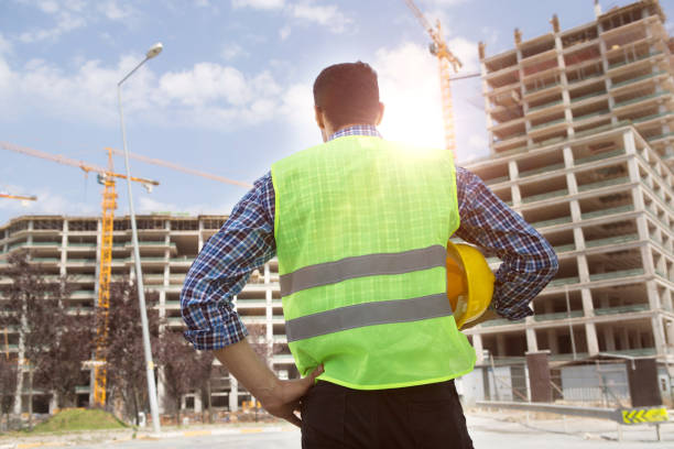 istock Young Engineer portrait with construction site and crane background. 1062657954