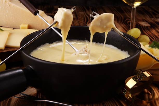 istock Gourmet Swiss fondue dinner on a winter evening with assorted cheese 1062669648