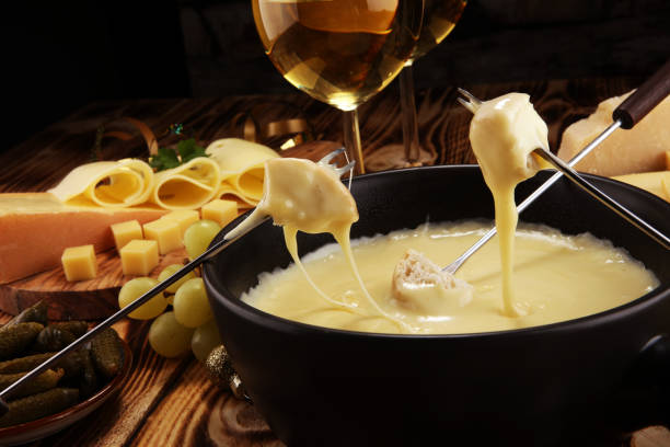istock Gourmet Swiss fondue dinner on a winter evening with assorted cheese 1062669760