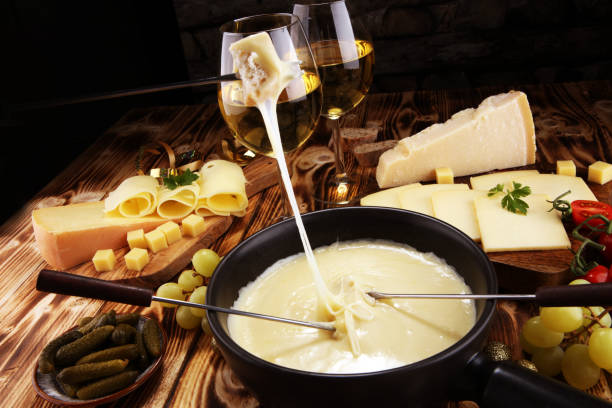 istock Gourmet Swiss fondue dinner on a winter evening with assorted cheese 1062670064