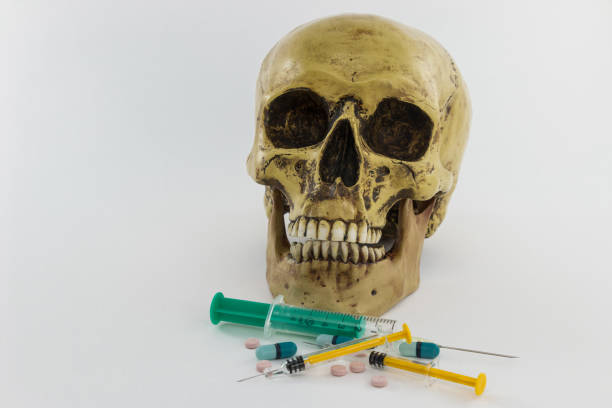istock Skull with syringes and pills 1062670276