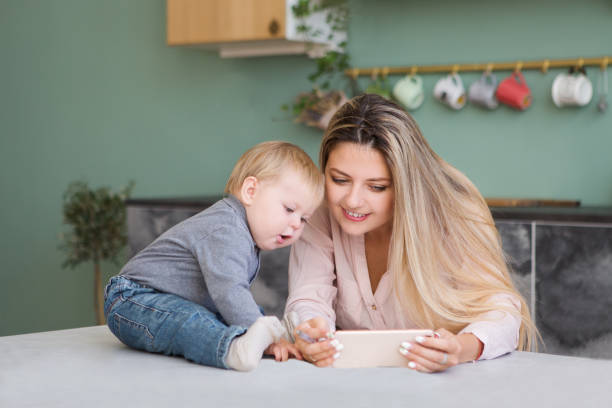 istock Young mother working and playing with her child from home. 1062671992