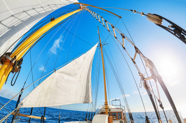 istock Old schooner sails against the sun. 1062677038