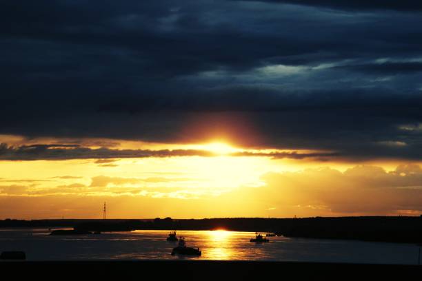 istock Beautiful sunset in the sky over the river 1062677264