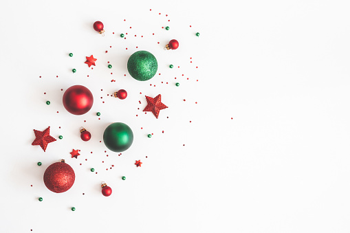 Christmas composition. Christmas red and green decorations on white background. Flat lay, top view, copy space
