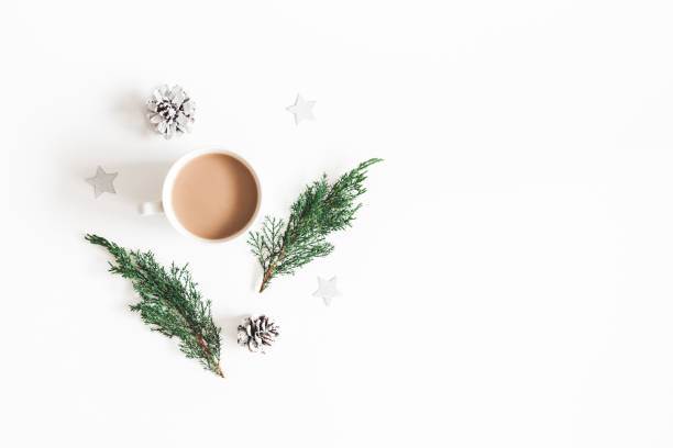 istock Christmas composition. Cup of coffee, fir tree branches, pine cones on white background. Flat lay, top view, copy space 1062680146
