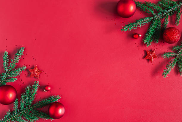 istock Christmas composition. Christmas red decorations, fir tree branches on red background. Flat lay, top view, copy space 1062680370