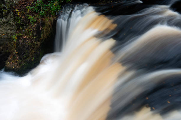 istock Waterfalls over black bed rock in Little Bushkill Creek 1062683678