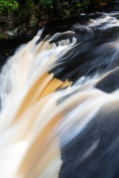 istock Waterfalls over black bed rock in Little Bushkill Creek 1062683758
