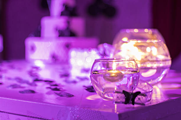 Candles on water. Birthday cake in background