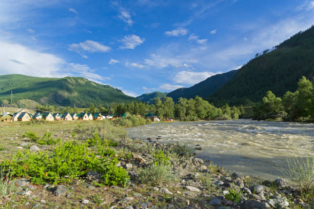 Сamp site on the river bank. Altai. Russia Сamp site on the bank of the Chuya River. The neighborhood of the village of Chibit, Altai, Russia. summer camp cabin stock pictures, royalty-free photos & images