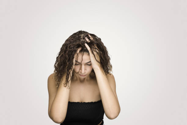 istock Depressed woman scratching head over grey background 1062698110