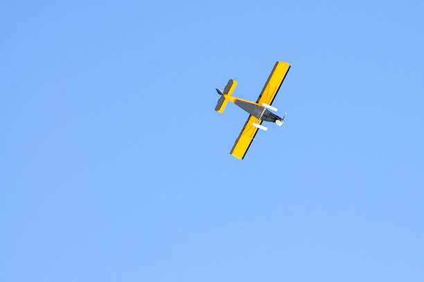 istock A yellow plane with a propeller on the blue sky 1062698464