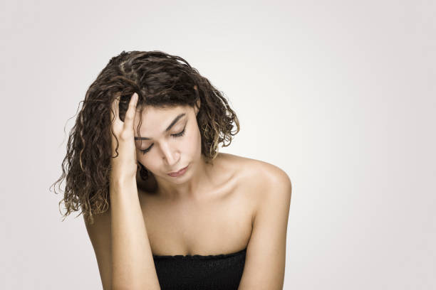 istock Depressed woman scratching head over grey background 1062698516