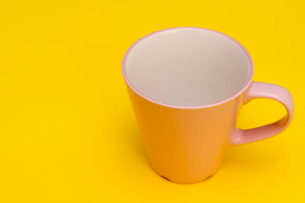istock Pink beautiful mug with handle on green background 1062698640