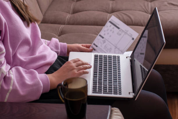 istock Student study sitting on the couch and studying the material on the laptop 1062699032