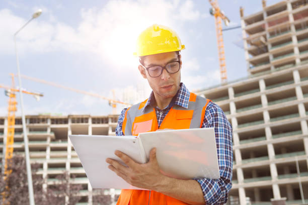 istock Young Engineer portrait with construction site and crane background. 1062712160