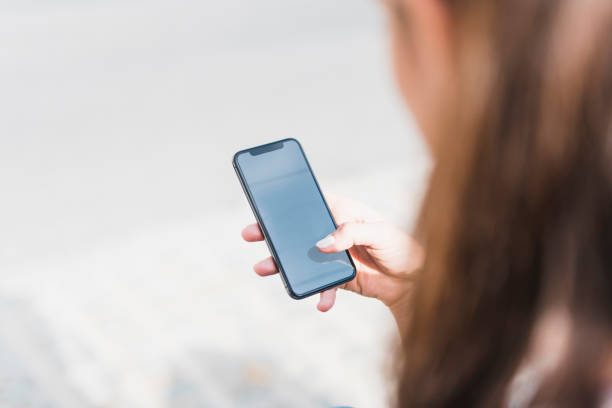istock Young woman holding a smart phone in her hands 1062724422