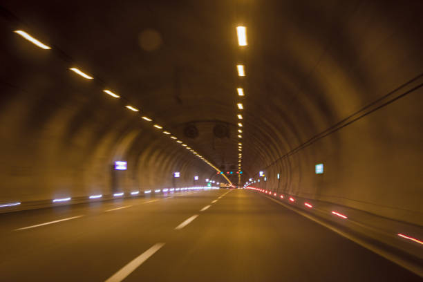 istock Motorway highway tunnel interior view, yellow light lighting, blurred vision 1062724740