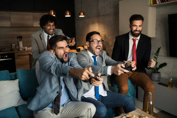 istock A group of young business man playing video games after work 1062727170