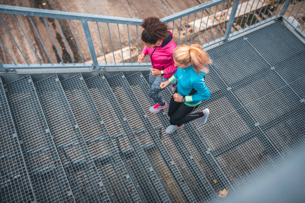 istock Young sportswomen running on stairs 1062737952