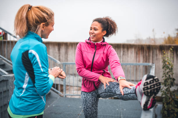 istock Young sportswomen stretching before sports training 1062738324