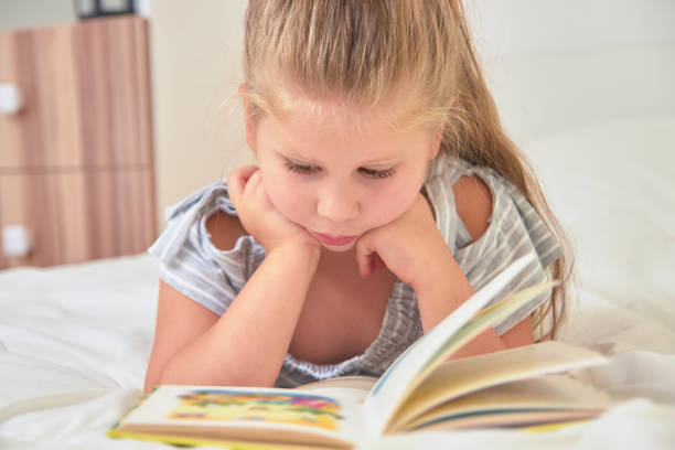 istock Girl reading lying on bed 1062738984
