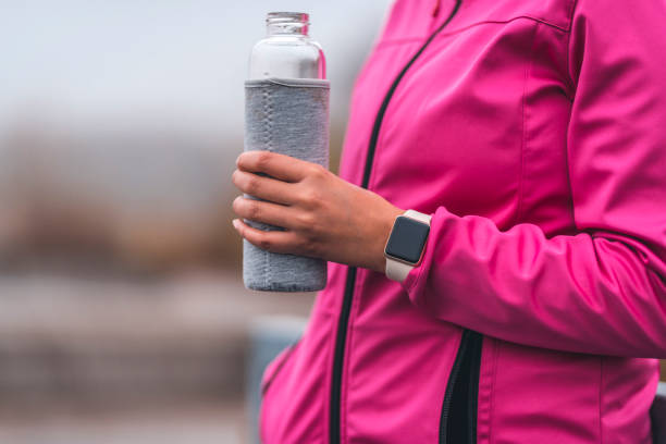 istock Young sportswoman drinking water after training 1062741674