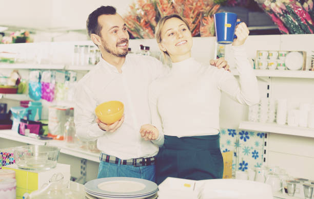 istock Couple examines cups and mugs 1062744596